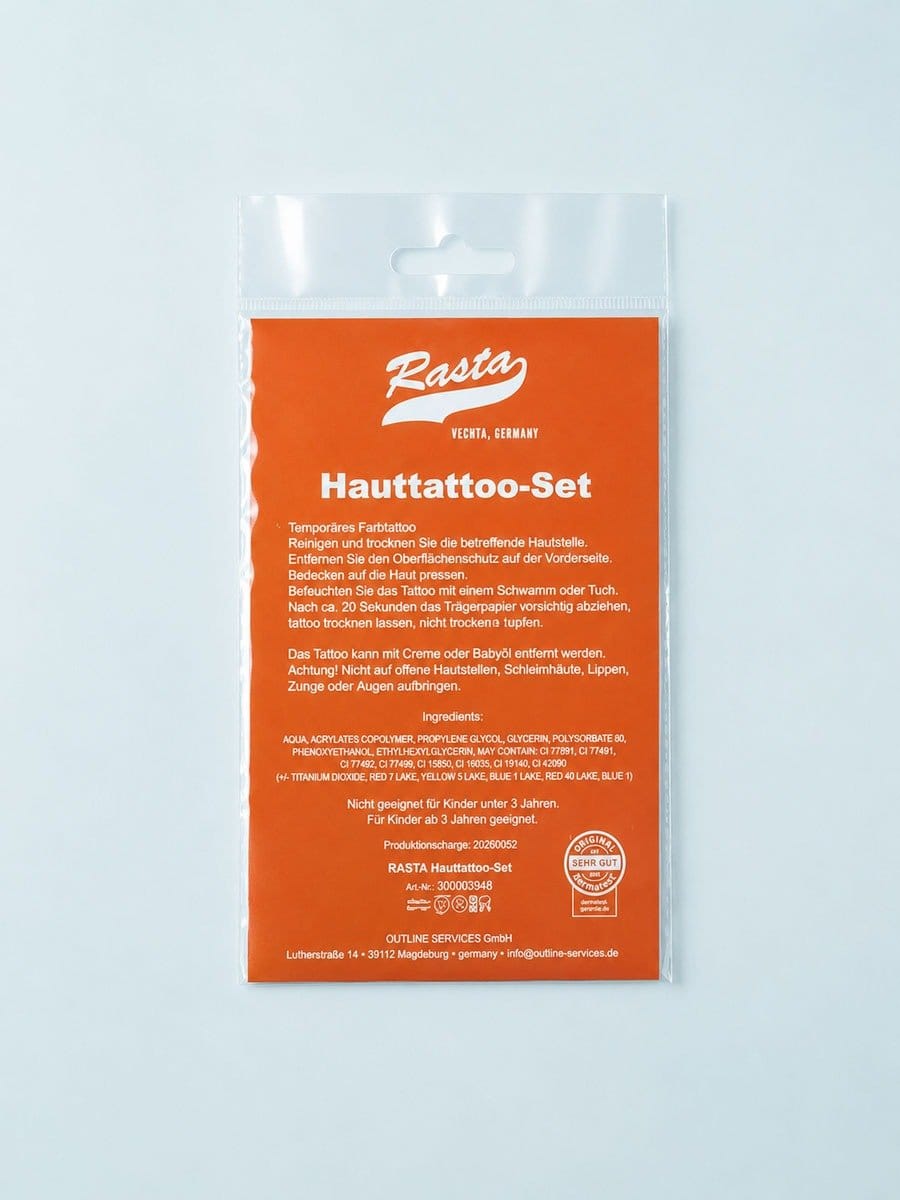 Hauttattoo-Set in einer transparenten Verpackung mit orangefarbenem Etikett, enthält Anweisungen, Inhaltsstoffe und Warnhinweise in deutscher Sprache.